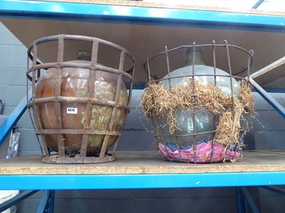 Lot 4070 - Two large glass Demijohns in metal frame baskets