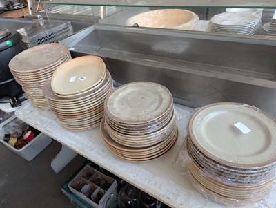 Lot 501 - 4 stacks of brown stoneware plates in various...