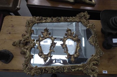 Lot 5113 - A mirror in decorative gilt frame with a pair...