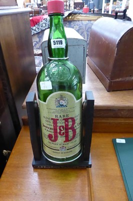 Lot 5119 - A large J & B whiskey bottle with stand