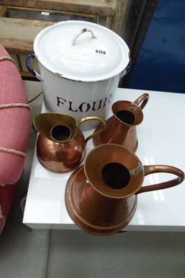 Lot 5158 - Three graduated copper and brass jugs with an...