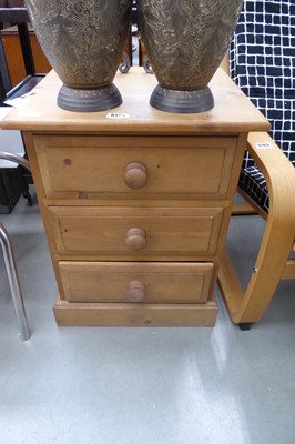 Lot 5161 - A pine three drawer bedside cabinet