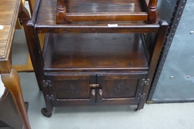 Lot 5171 - An oak two-tier tea trolley with cupboard under