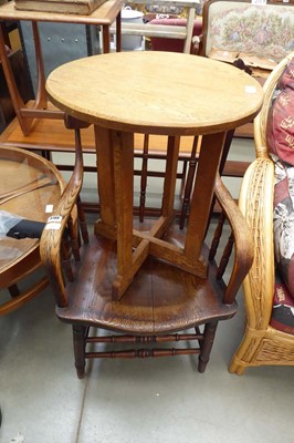 Lot 5199 - An oak armchair with a circular side table