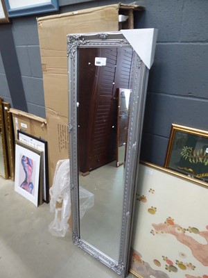 Lot 5301 - Narrow and rectangular bevelled mirror in a...