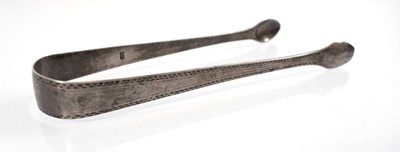 Lot 305 - A pair of George III silver sugar tongs by...