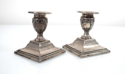 Lot 321 - A pair of Edwardian silver dwarf candlesticks,...