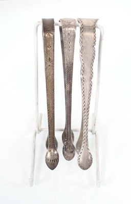 Lot 324 - A group of three pairs of metalwares sugar...