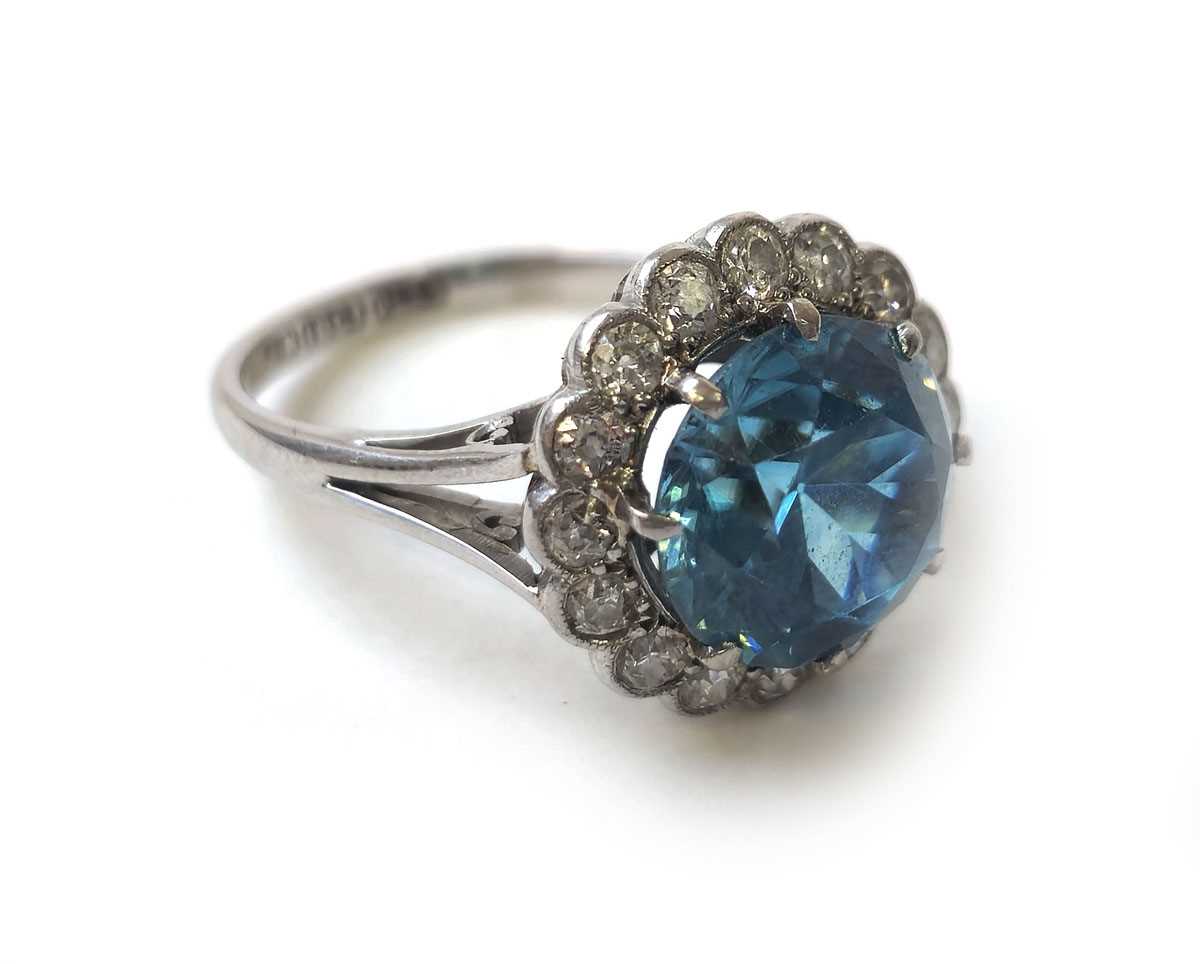 Lot 402 - A white metal aquamarine and diamond cluster...