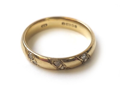 Lot 407 - A 9ct gold band set with three diagonal lines...