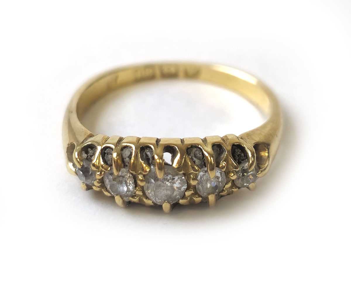 Lot 411 - An early 20th century 18ct gold and five stone...