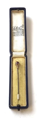 Lot 420 - A yellow metal and amethyst stick pin in box....