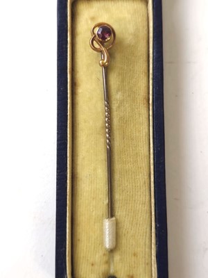 Lot 420 - A yellow metal and amethyst stick pin in box....