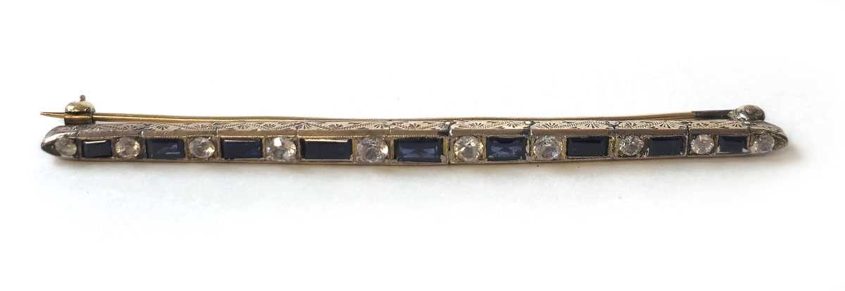 Lot 424 - An early 20th century yellow metal, blue and...