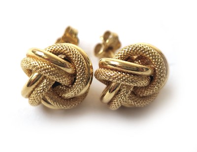Lot 427 - A pair of 18ct gold knot earrings. Approx....