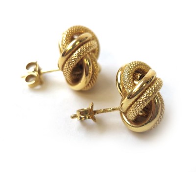 Lot 427 - A pair of 18ct gold knot earrings. Approx....