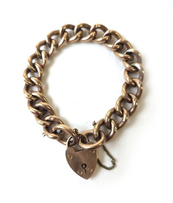 Lot 434 - A yellow metal curb bracelet with heart...