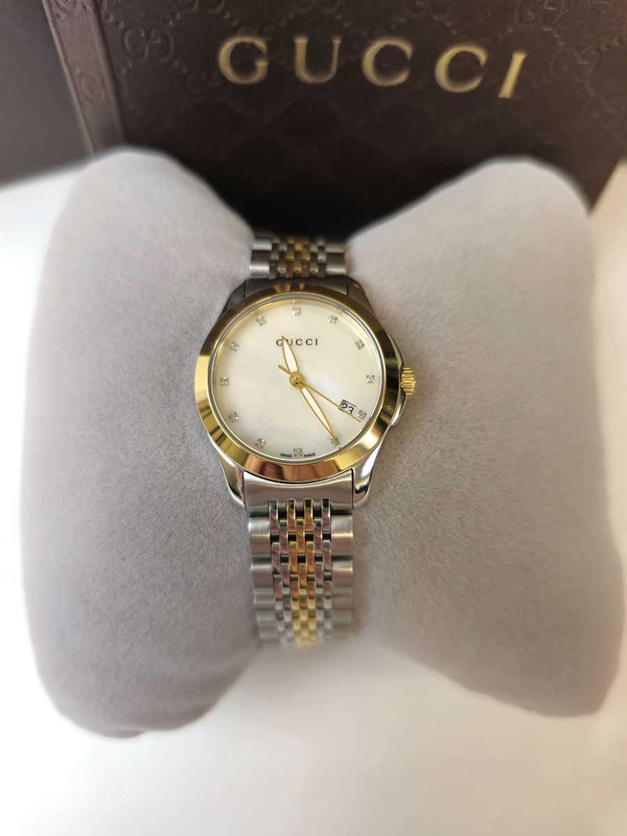 Lot 452 - A ladies Gucci G-Timeless wristwatch together...