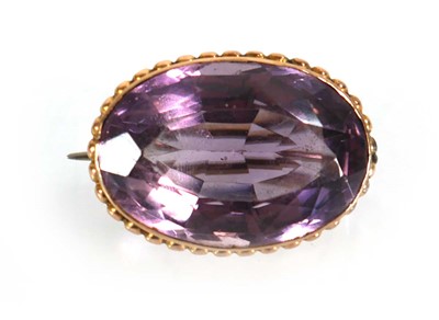 Lot 558 - A yellow metal brooch set oval amethyst...
