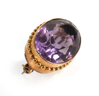 Lot 558 - A yellow metal brooch set oval amethyst...