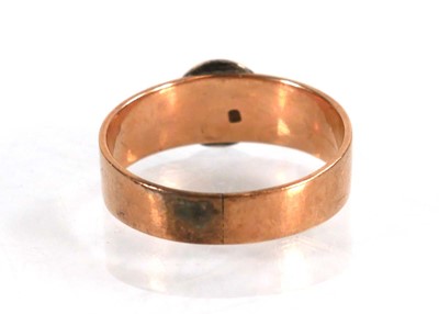 Lot 559 - A yellow metal ring set cabochon red stone in...