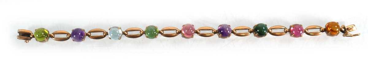 Lot 560 - A 9ct yellow gold bracelet set nine coloured...