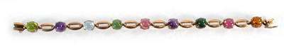 Lot 560 - A 9ct yellow gold bracelet set nine coloured...