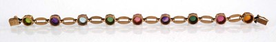 Lot 560 - A 9ct yellow gold bracelet set nine coloured...