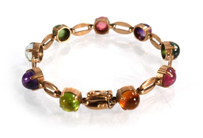 Lot 560 - A 9ct yellow gold bracelet set nine coloured...
