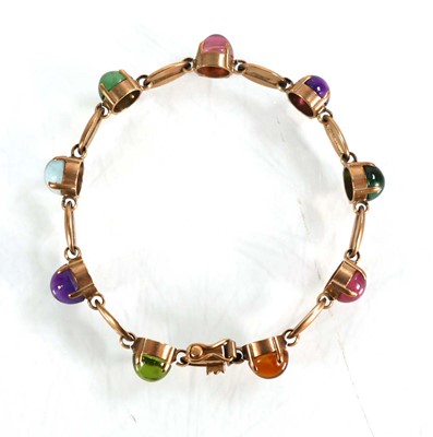 Lot 560 - A 9ct yellow gold bracelet set nine coloured...