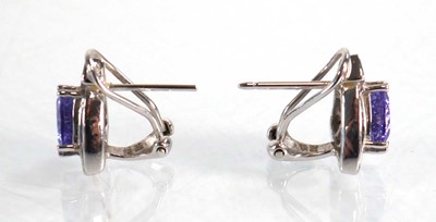 Lot 563 - A pair of 14ct white gold ear studs, each set...