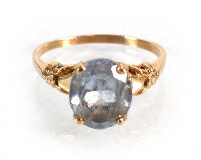 Lot 564 - A yellow metal ring set oval pale blue topaz...