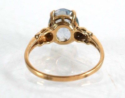 Lot 564 - A yellow metal ring set oval pale blue topaz...