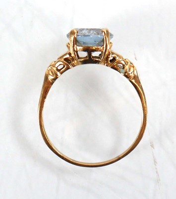 Lot 564 - A yellow metal ring set oval pale blue topaz...