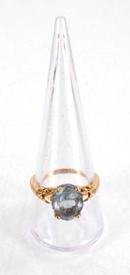 Lot 564 - A yellow metal ring set oval pale blue topaz...