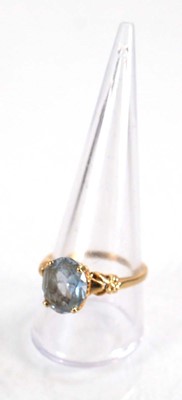 Lot 564 - A yellow metal ring set oval pale blue topaz...