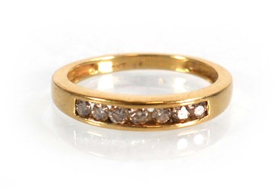 Lot 566 - An 18ct yellow gold half eternity ring set...