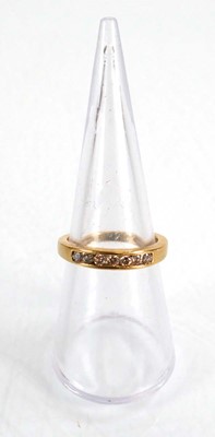 Lot 566 - An 18ct yellow gold half eternity ring set...