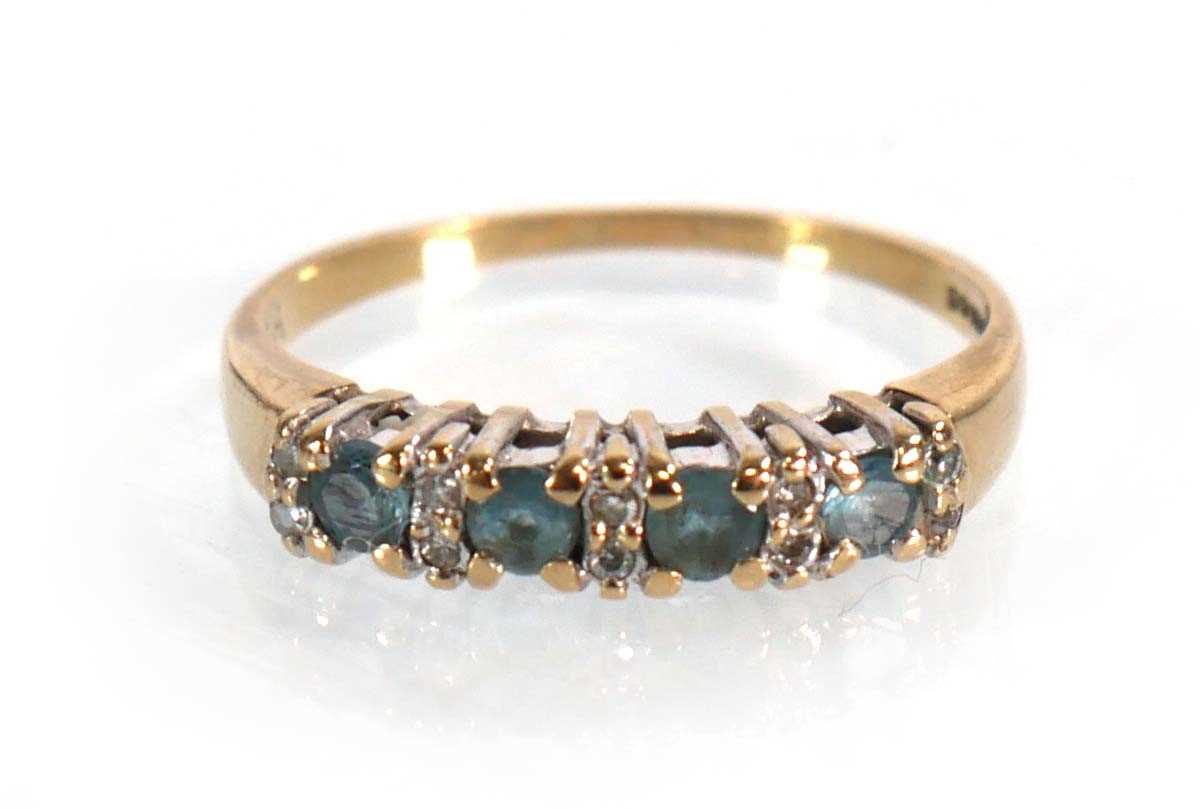 Lot 567 - A 9ct yellow gold half eternity ring set four...