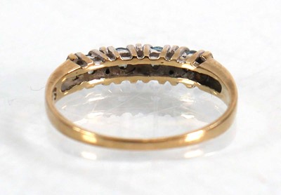 Lot 567 - A 9ct yellow gold half eternity ring set four...