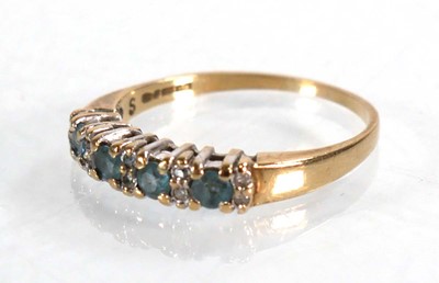 Lot 567 - A 9ct yellow gold half eternity ring set four...