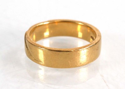 Lot 570 - An 18ct yellow gold wedding band with wave...