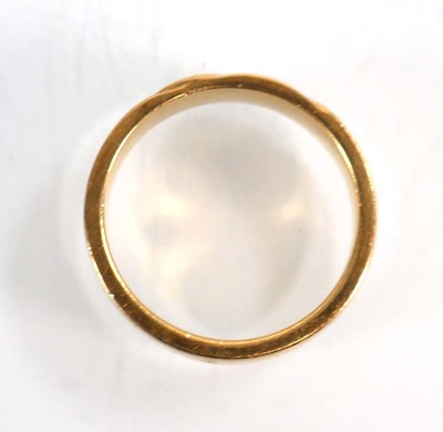 Lot 570 - An 18ct yellow gold wedding band with wave...