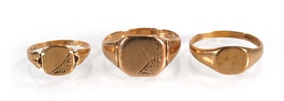 Lot 574 - Three 9ct yellow gold signet rings, ring sizes...