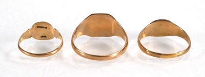 Lot 574 - Three 9ct yellow gold signet rings, ring sizes...