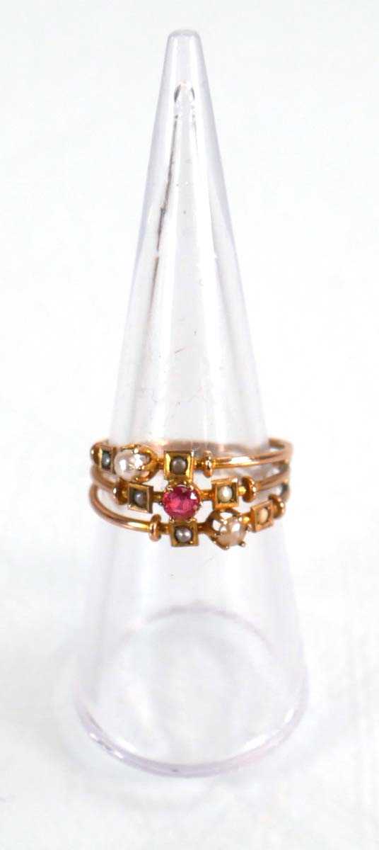 Lot 575 - A 9ct yellow gold triple shank ring set pink...