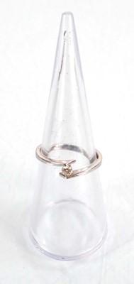 Lot 581 - An 18ct white gold cross ring set small...