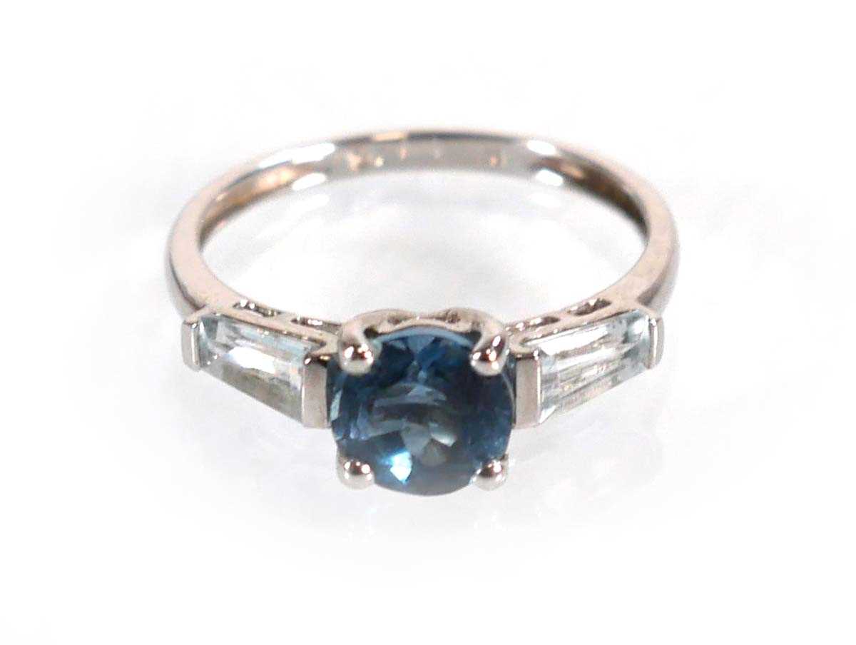 Lot 582 - A 9ct white gold ring set three graduated pale...