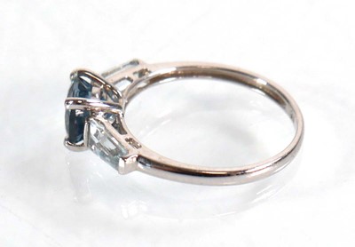 Lot 582 - A 9ct white gold ring set three graduated pale...