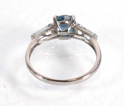 Lot 582 - A 9ct white gold ring set three graduated pale...